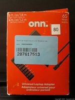 Front of red onn box showing 65 W rating and adapter image