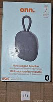 Front of retail box showing onn. Mini Rugged Speaker, IPX5, 7-hour rating