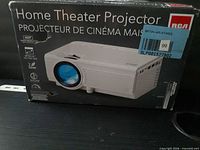 Front of RCA projector box showing product image and model features