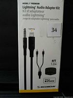 Front of box showing Scosche HookUp Premium Lightning Audio Adapter Kit, cable image, length 4 ft, model branding