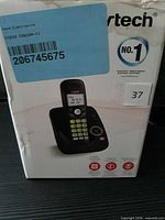 Front of retail box showing handset and base, model label