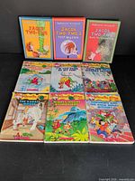 Nine books laid out showing full covers