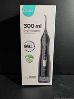 Front of Coslus oral irrigator retail box showing product image and key specs
