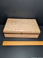 Closed keepsake box with ruler showing length