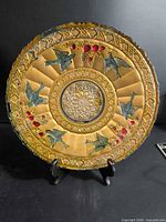 Full view of round pressed glass plate on stand