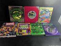 All seven books front covers visible side by side