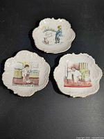 Group shot of all three porcelain dishes showing size, shape, gilt rims and illustrations