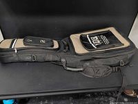 Full view of black and tan Profile gig bag showing exterior pockets, straps and overall condition