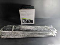 Seat cover boxed beside folded windshield thermal cover