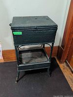Full view of wicker sewing side table showing shape and lower shelf