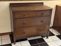 front view of oak chest showing three drawers and hardware