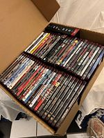Open box showing full quantity of HD-DVDs in two columns