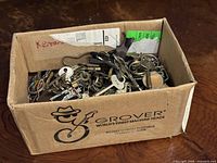 full view of box filled with mixed keys and rings