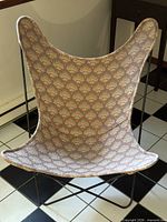 Front view of butterfly chair showing full frame and fabric seat