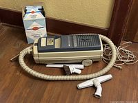 Canister vacuum, hose, attachments, filter box overview