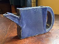 Left side view showing spout, rectangular form and glaze