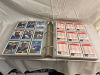 Open binder showing multiple pages of baseball cards