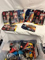Overview of carded figures, boxed Speeder Bike, loose toy bin