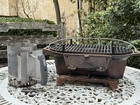 Lodge Sportsman Pro cast iron grill and Weber chimney starter on table