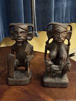 Both wooden ancestor figures side by side