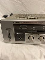 Front left view showing model designation, controls and headphone jack