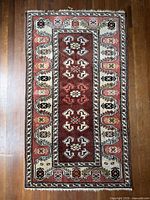 Full view of the rug showing overall design, colours and condition