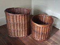 Tall oval and short round wicker baskets side by side