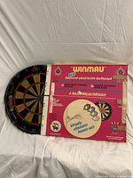 Dartboard alongside original red Winmau box