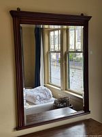 Full view of mirror hanging on wall