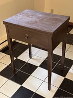 Full view of wooden sewing table front and side