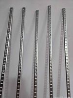 Close view of front face detailing slots and holes on standards