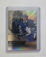 Front of Mitch Marner rookie card in protective holder showing foil design and player imagery
