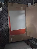 Stack of three sheet-metal panels (white on top, red beneath) showing size and coating