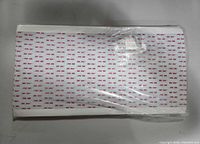 Top view of stack of 3M tape sheets showing repeating 3M logo liner