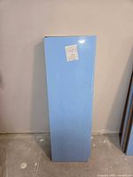 Four stacked MDF panels with blue film, showing dimensions label