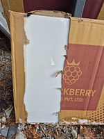 Loose Alvino Statuario tile leaning on branded box