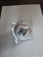 Front view showing MLB World Series logo on ball inside display case