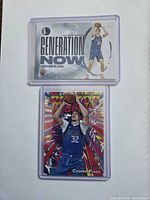 Front view of both Cooper Flagg Topps rookie cards in top-loaders