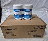 Case with two sample canisters on top showing branding and label details