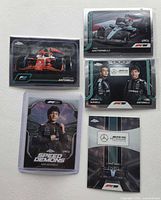 Front view of five Topps Chrome cards showing images and titles