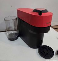 Front view of red and black Nespresso Vertuo Pop+ with water reservoir and open drip tray