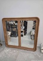 Front view of mirror showing wood frame and dual panels