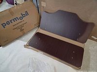Headboard and footboard panels displayed on box marked Permobil with product information