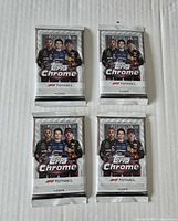 Front view of all four Topps Chrome Formula 1 sealed packs