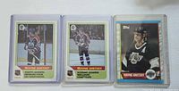 Front view of three Wayne Gretzky hockey cards in sleeves