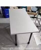 Angled view of tabletop and two legs