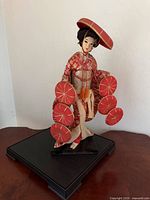Full view of geisha doll on stand