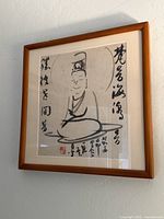 Full view of framed Asian ink brush painting on wall