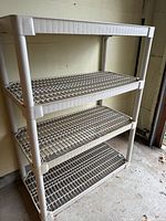 Overall view of Contico 4-tier plastic shelf unit in garage