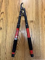 Full view of Corona lopper with red handles and bypass blades